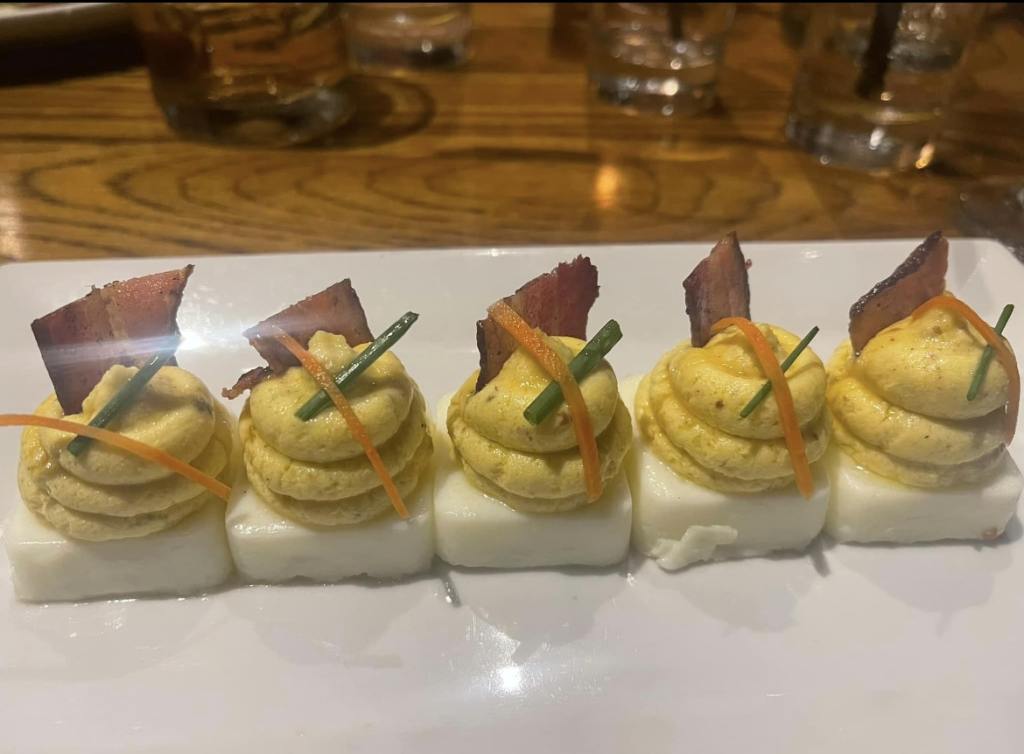 deviled eggs on a plate at burwell's stone fire grill in charleston, one of most expensive travel destinations in the U.S. and best places to travel alone